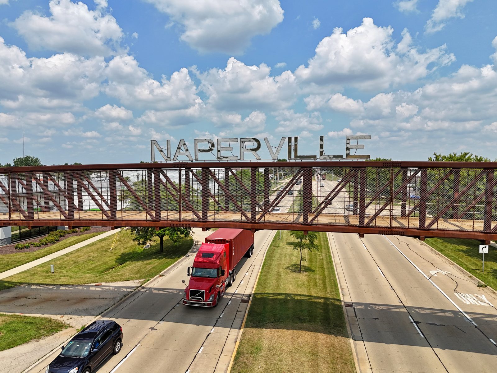 Naperville bridge and welcome sign over the waterway