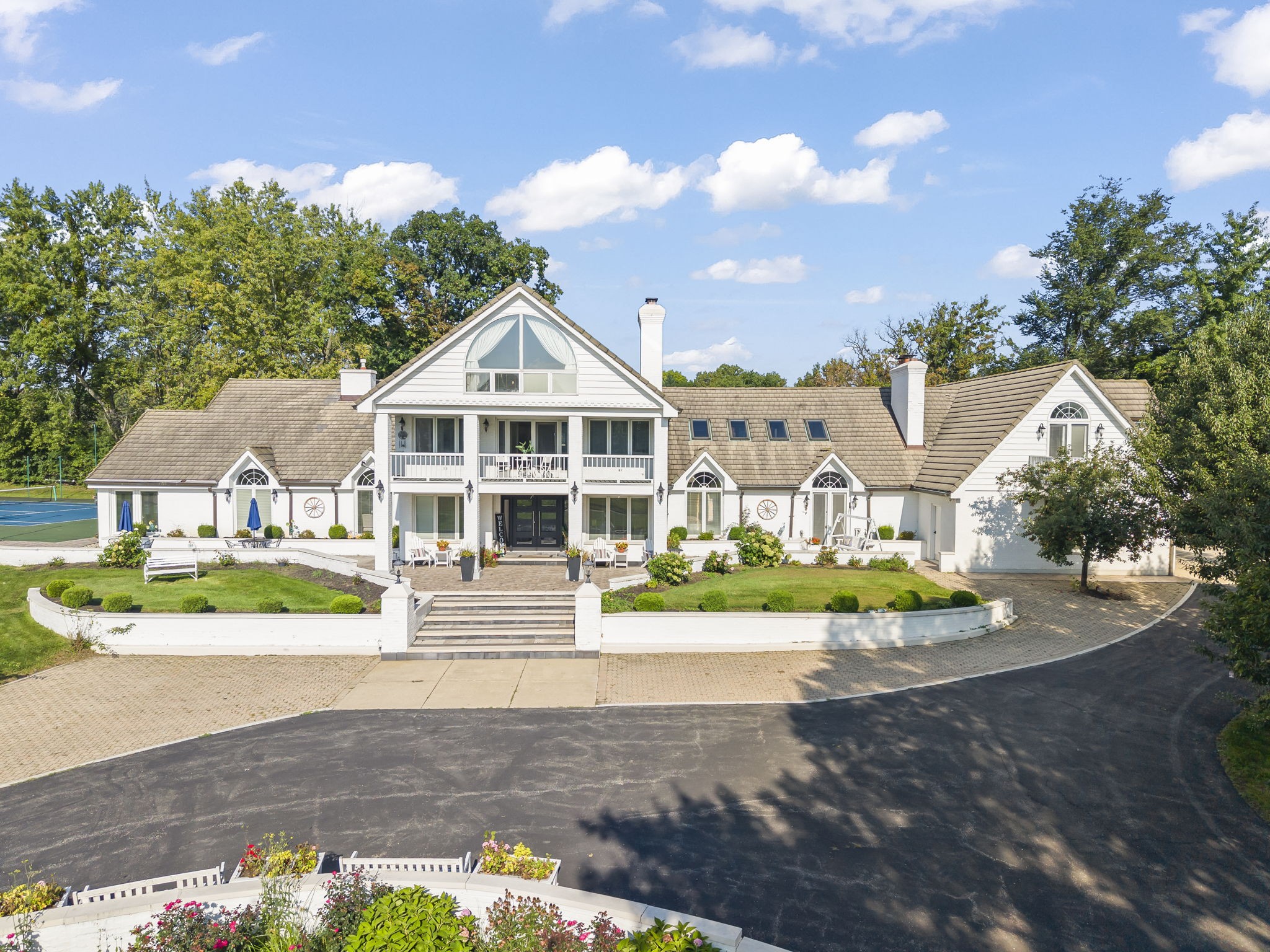 Greene Valley forest preserve area Naperville estate rear aerial at 23W735 Hobson Rd showing 2.65 private acres of lush lawn, flagstone patios, fire pit lounge, and mature trees