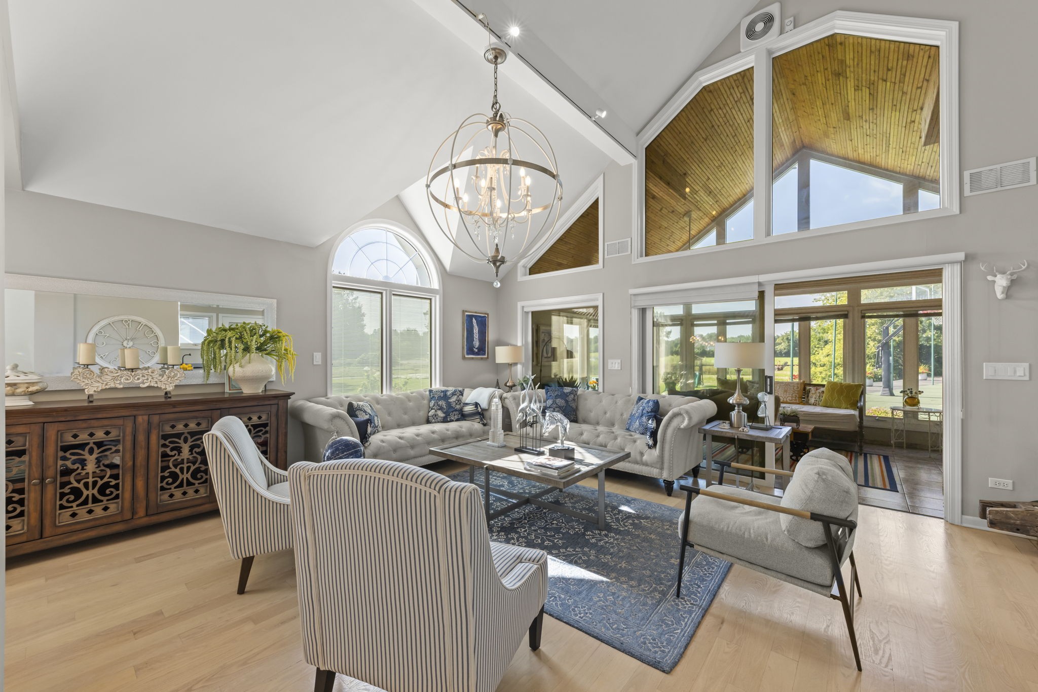 Naperville estate gourmet chef's kitchen at 23W735 Hobson Rd showcasing oversized waterfall marble island, designer pendant lighting, and adjoining breakfast nook