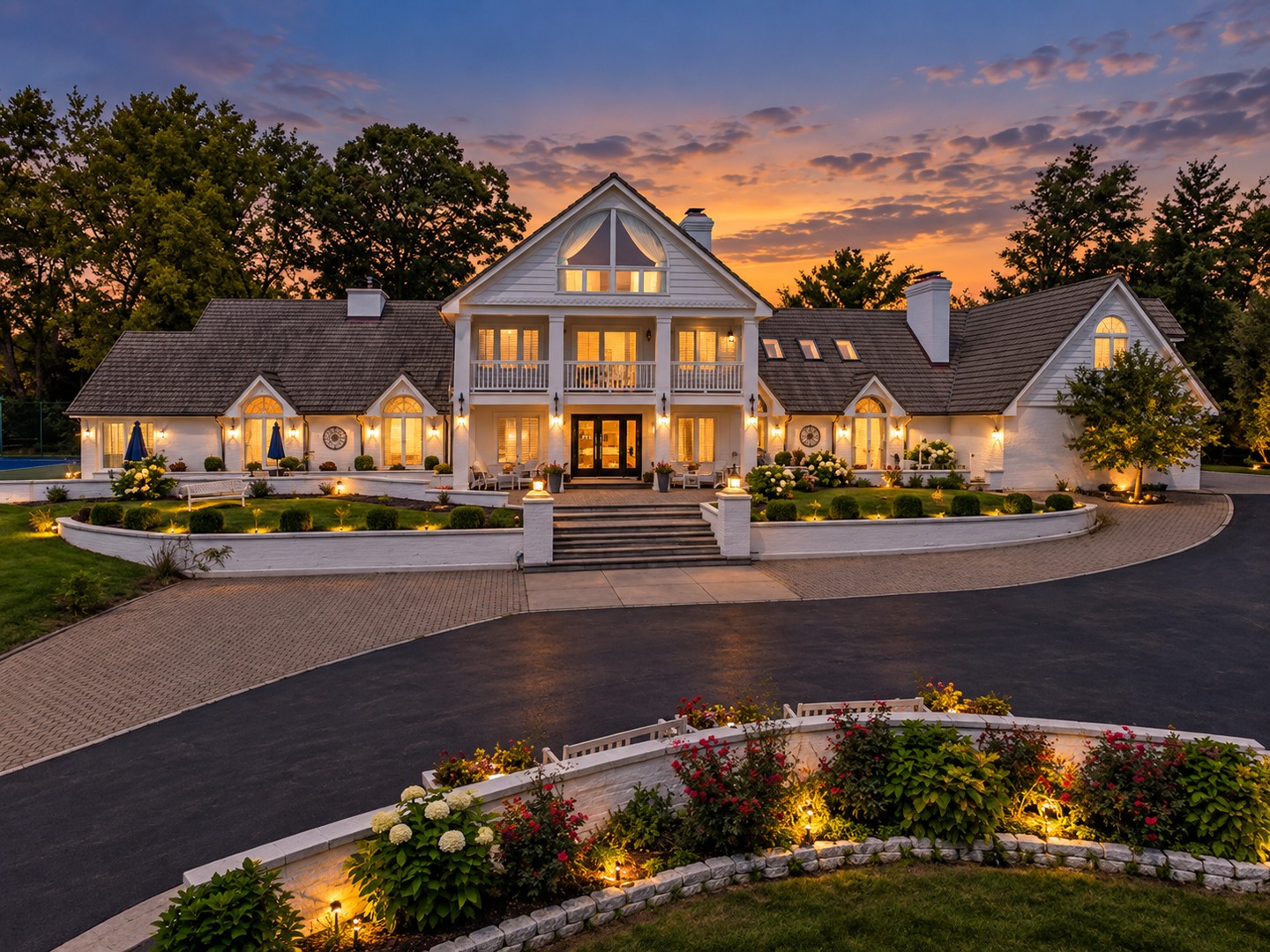Woods of Hobson Green area Naperville luxury estate at 23W735 Hobson Rd captured at twilight with exterior architectural landscape lighting and warm window glow